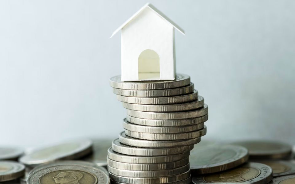 house stacked on coins