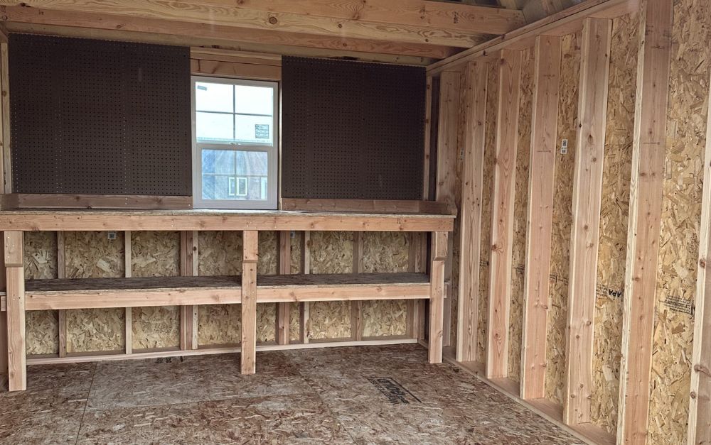 The inside of a shed with wooden walls and a window.